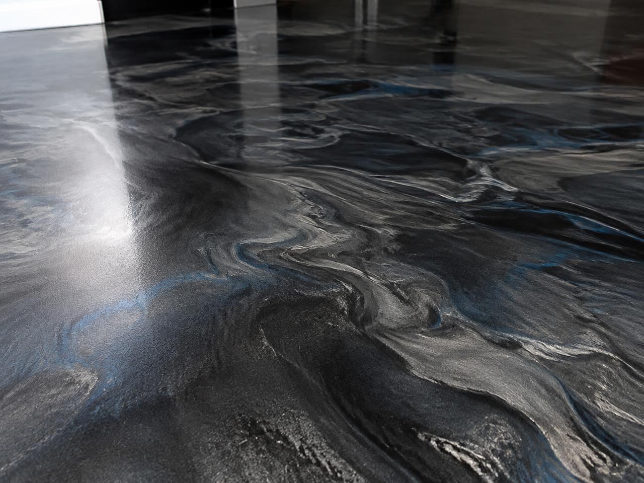 Close view of a charcoal and silver metallic epoxy floor with blue highlights