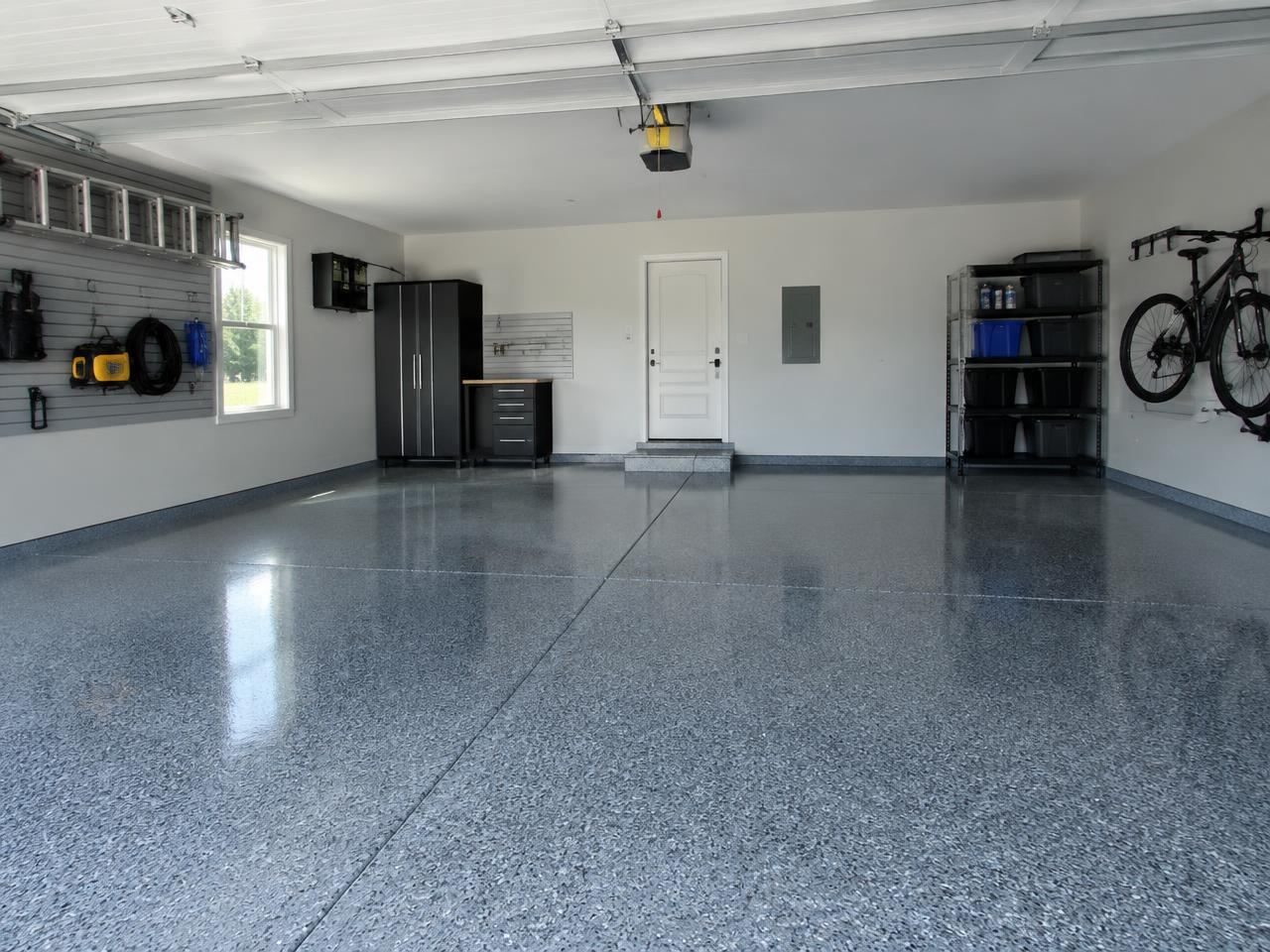 Finished garage with a grey flake coated floor and wall storage